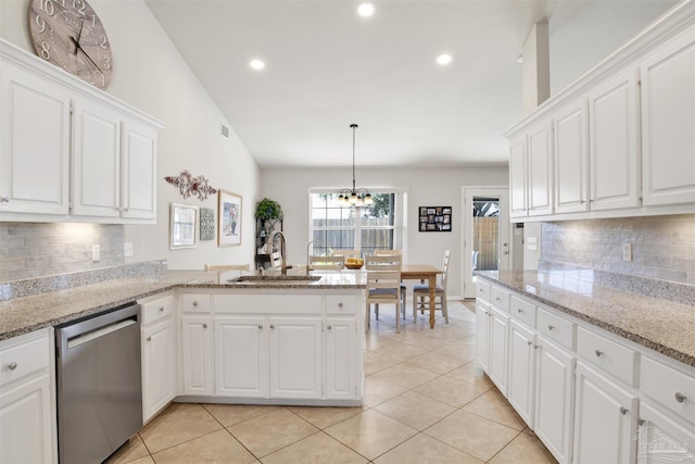 kitchen with stainless steel dishwasher, white cabinets, tasteful backsplash, and sink