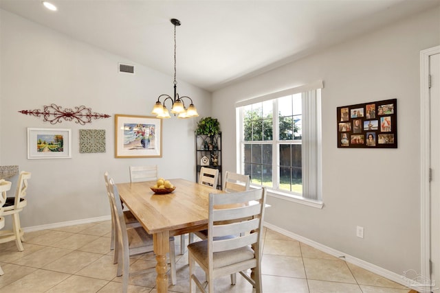 dining area with light tile patterned floors, vaulted ceiling, and a chandelier