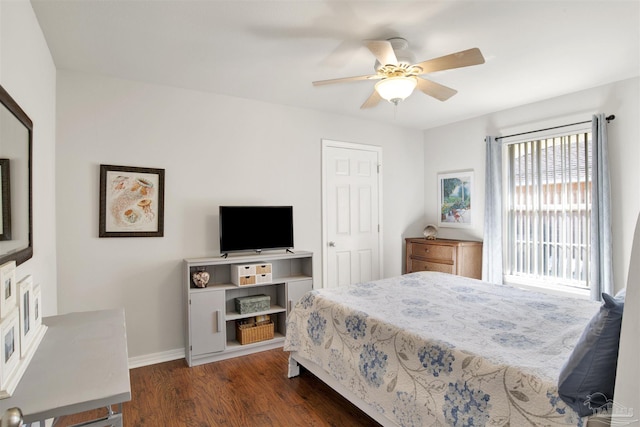 bedroom with ceiling fan and dark hardwood / wood-style flooring