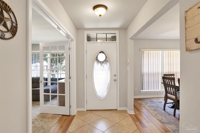 entrance foyer featuring french doors and light hardwood / wood-style flooring