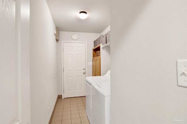 washroom with independent washer and dryer and light tile patterned flooring