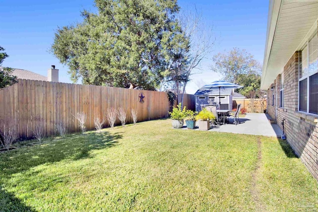 view of yard featuring a shed and a patio