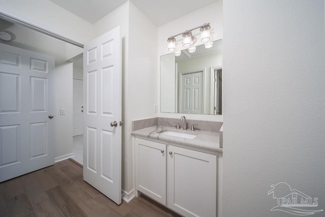 bathroom with wood finished floors and vanity