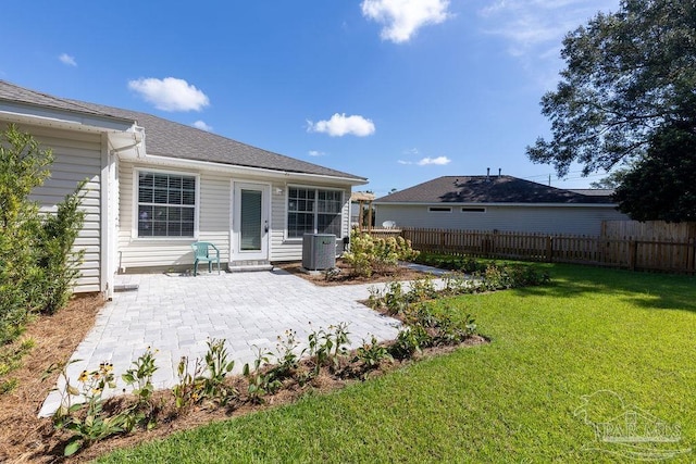 back of house with a patio area, a lawn, central AC unit, and fence