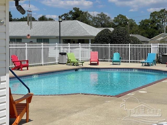 community pool featuring a patio and fence