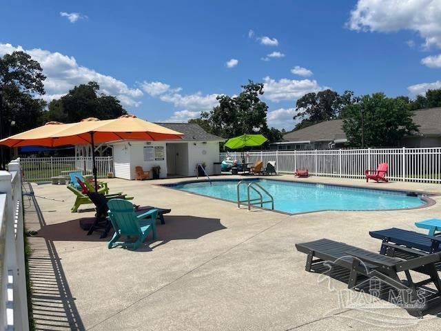 pool with fence and a patio area