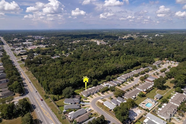 birds eye view of property with a forest view