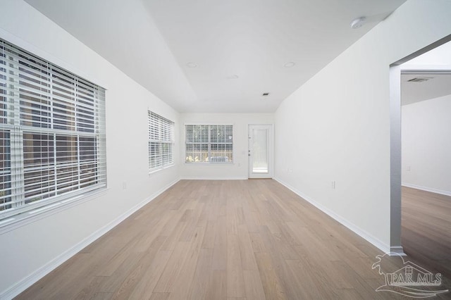 interior space featuring visible vents, baseboards, and wood finished floors