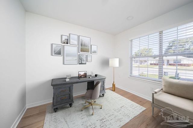 home office with wood finished floors and baseboards