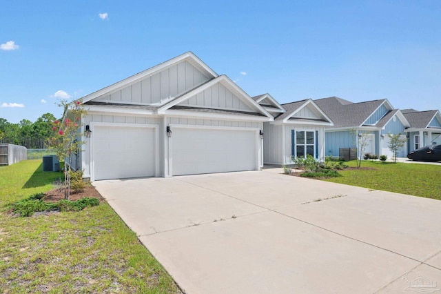 view of front of house with central AC, a garage, and a front lawn