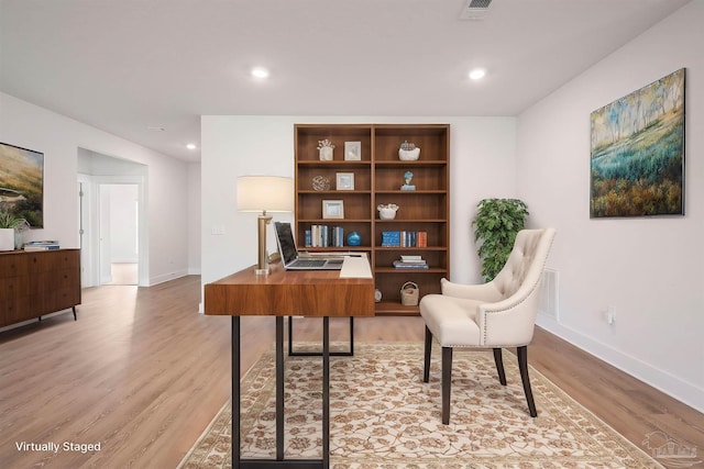 office area with light hardwood / wood-style floors