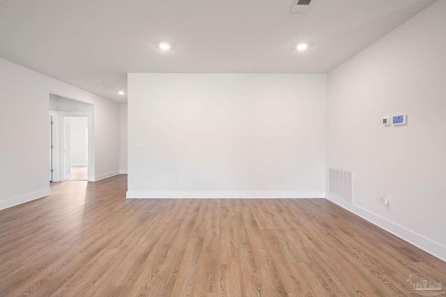 spare room with light wood-type flooring