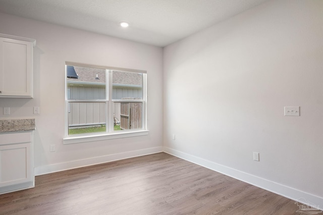 unfurnished dining area featuring wood-type flooring