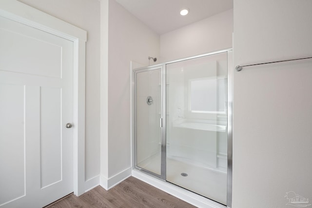 bathroom with wood-type flooring and walk in shower