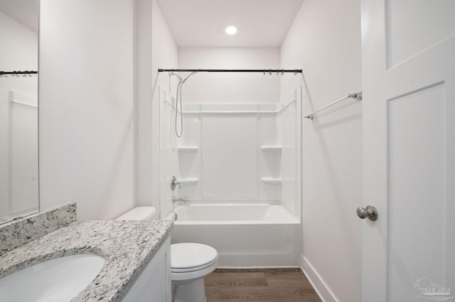 full bathroom featuring shower / tub combination, vanity, hardwood / wood-style floors, and toilet