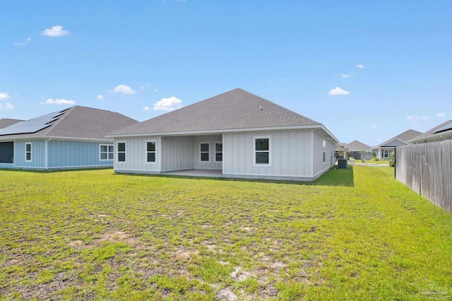 rear view of house featuring a yard and a patio area