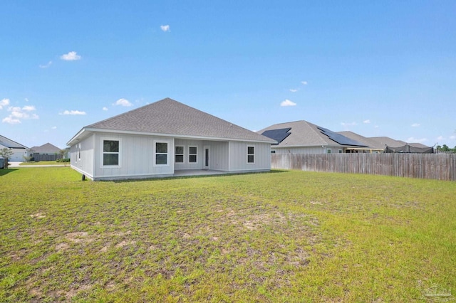 back of house with a yard