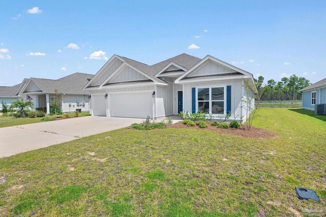 view of front of property with central AC unit, a garage, and a front yard