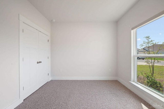 unfurnished bedroom with carpet floors and a closet