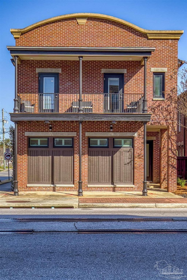 view of front of house featuring a garage and a balcony