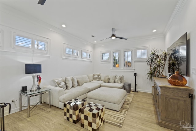 living room featuring crown molding, ceiling fan, and light wood-type flooring