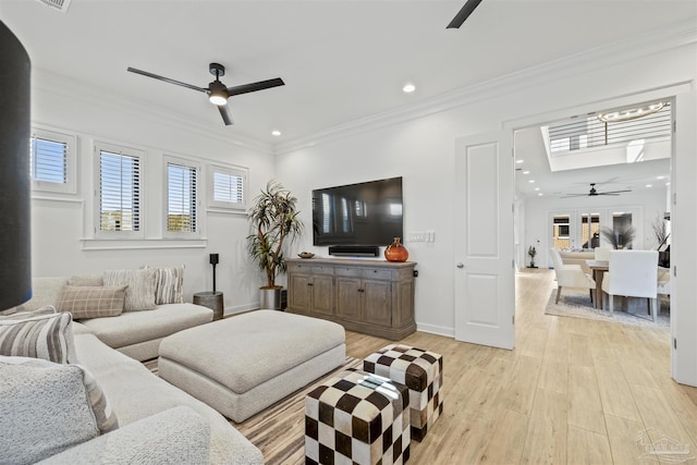 living room featuring crown molding, ceiling fan, and light hardwood / wood-style flooring