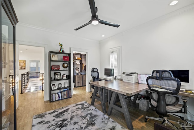 office area with light hardwood / wood-style flooring, ornamental molding, and ceiling fan