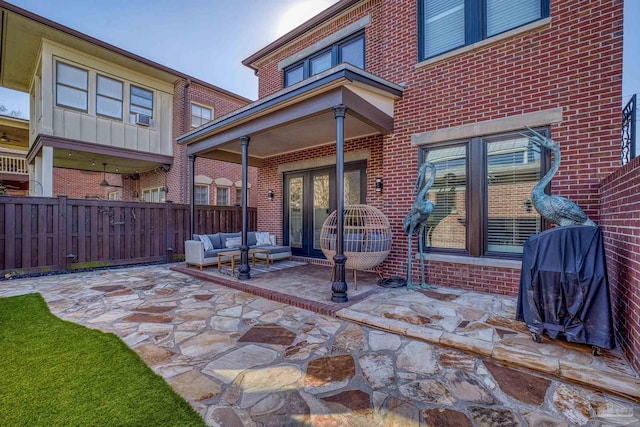 back of house with french doors, an outdoor hangout area, and a patio