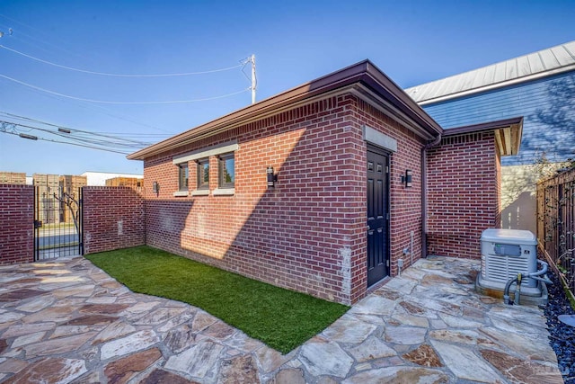 view of property exterior with central air condition unit and a patio area