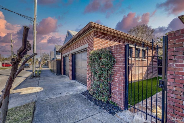 view of garage at dusk