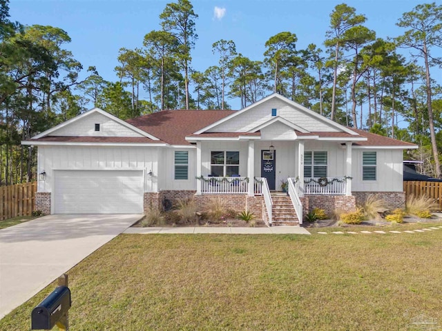 view of front facade featuring a garage, covered porch, and a front yard