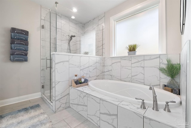 bathroom featuring separate shower and tub