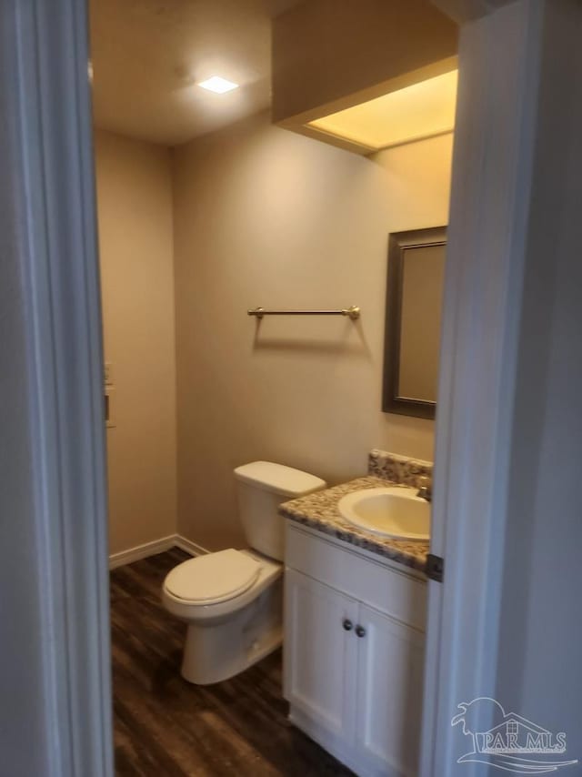 bathroom featuring vanity, hardwood / wood-style floors, and toilet