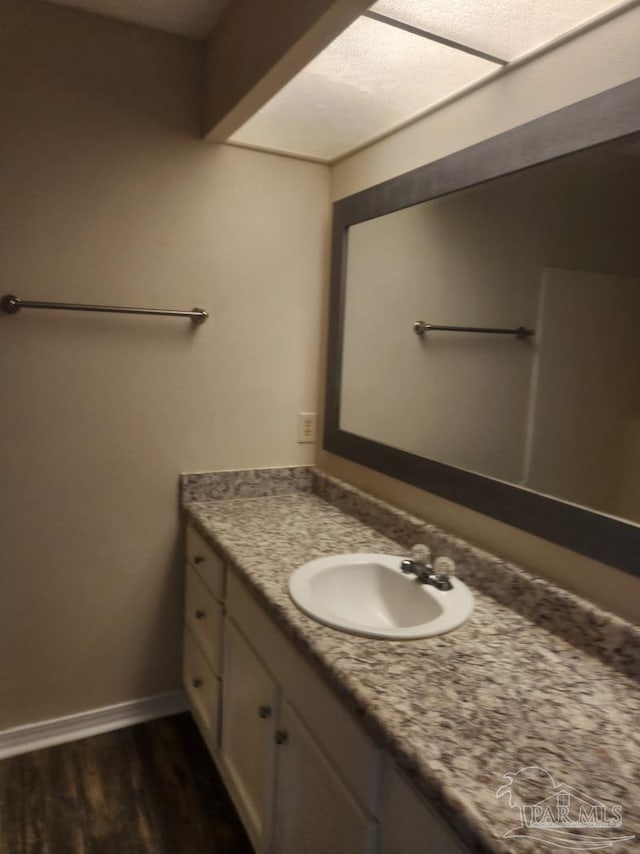 bathroom featuring vanity and wood-type flooring