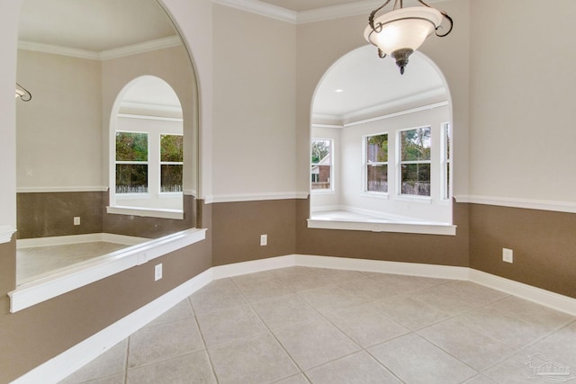 bathroom with tile patterned flooring, crown molding, and plenty of natural light