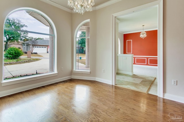 interior space featuring hardwood / wood-style flooring, crown molding, and a chandelier