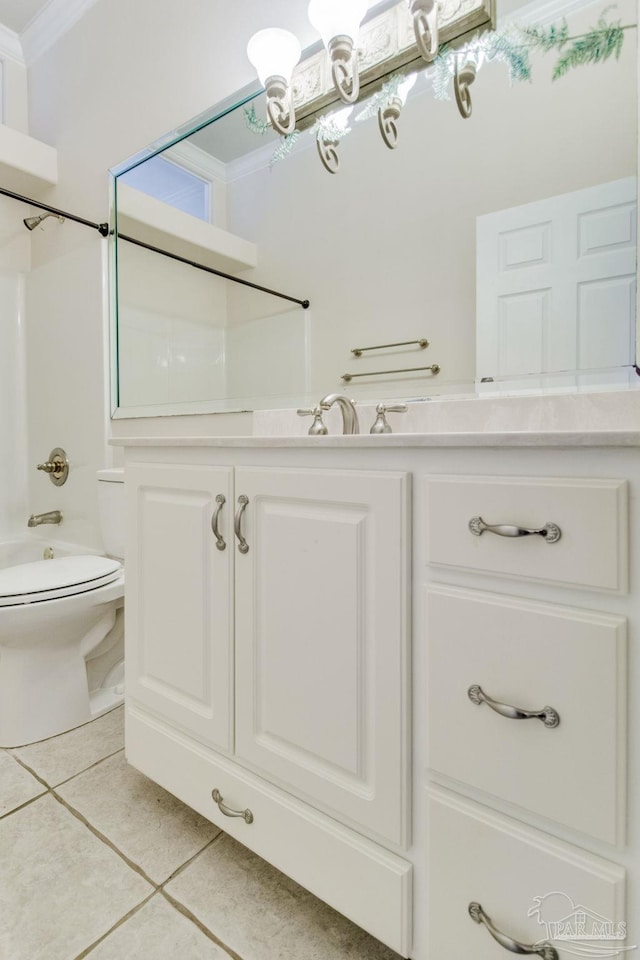 full bathroom featuring ornamental molding, vanity, toilet, tile patterned floors, and washtub / shower combination