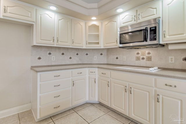 kitchen featuring decorative backsplash and white cabinets