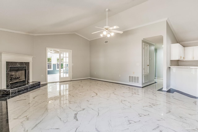 unfurnished living room featuring ceiling fan, lofted ceiling, crown molding, and a premium fireplace