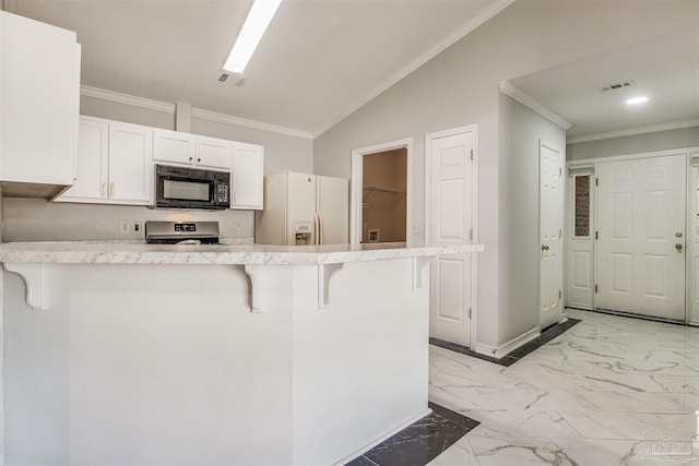 kitchen featuring white fridge with ice dispenser, kitchen peninsula, lofted ceiling, a kitchen bar, and white cabinets