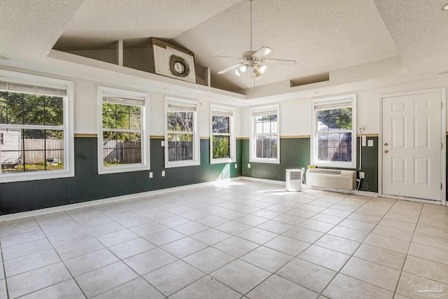 interior space with an AC wall unit, ceiling fan, and lofted ceiling