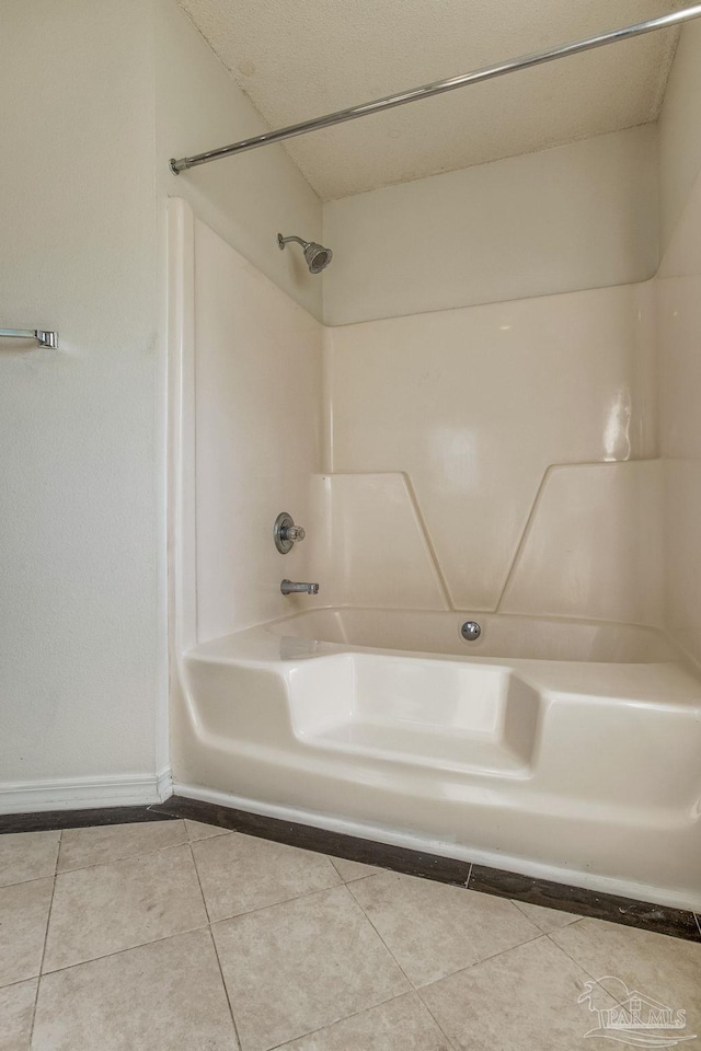 bathroom with tile patterned floors and shower / washtub combination