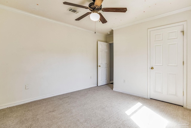 unfurnished bedroom with ceiling fan, light colored carpet, and ornamental molding