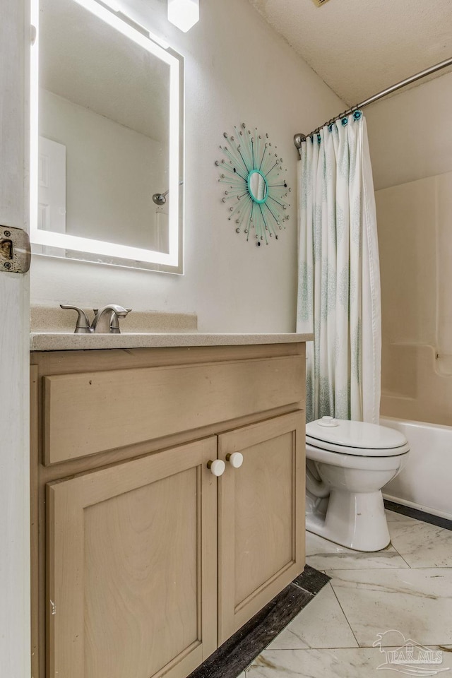 full bathroom with vanity, shower / tub combo, and toilet