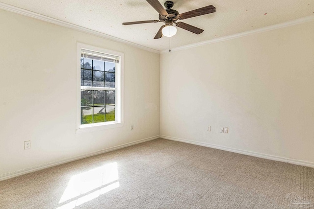 carpeted empty room featuring a textured ceiling, ceiling fan, and ornamental molding