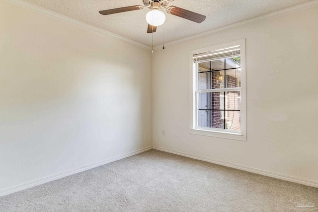 carpeted empty room featuring a textured ceiling, ceiling fan, and crown molding