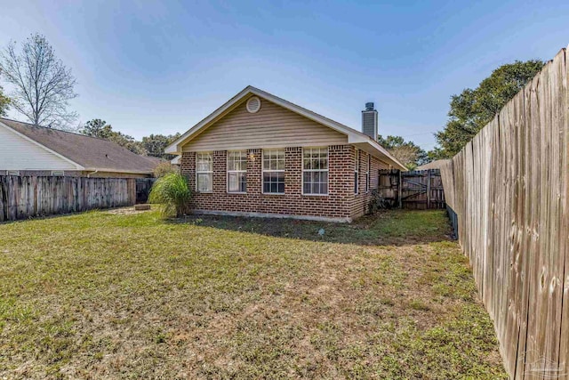 rear view of house featuring a lawn