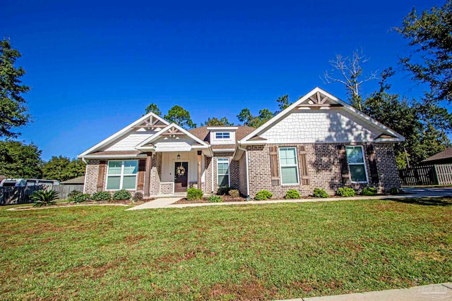 craftsman inspired home with a front lawn