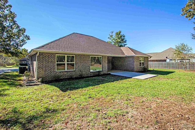 back of house with a yard, cooling unit, and a patio area