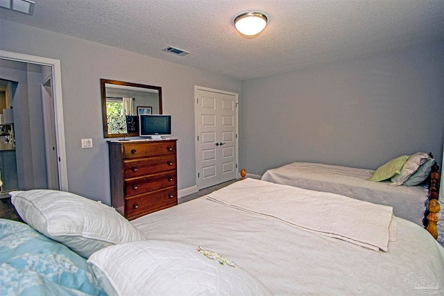 bedroom featuring a textured ceiling